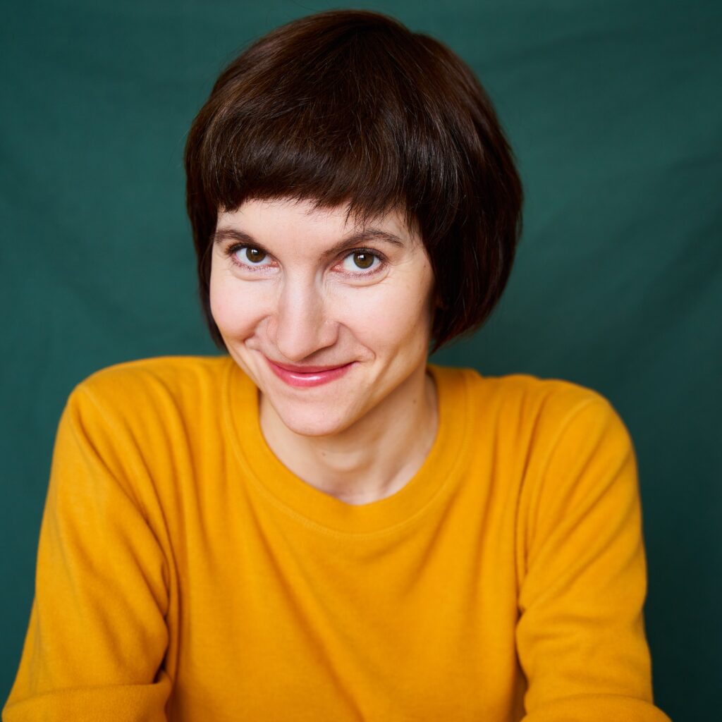 Smiling mature brunette woman looking playful and defiant, close-up portrait of middle-aged female
